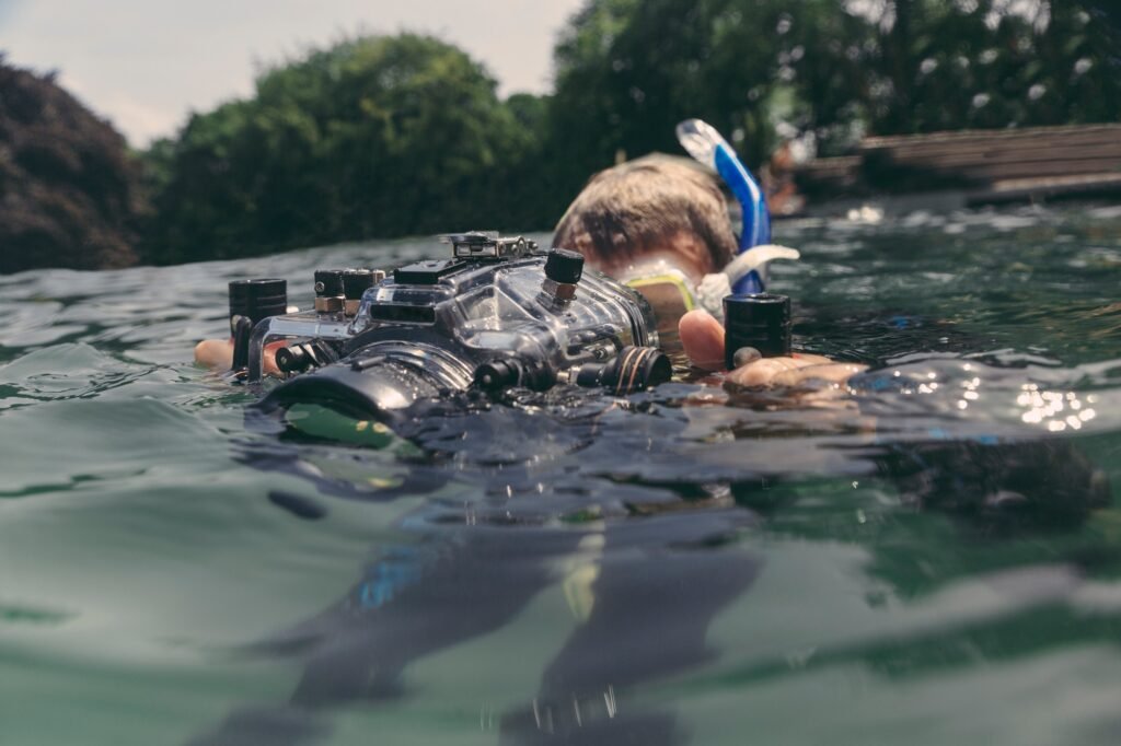 Man with underwater DSLR camera case in a lake